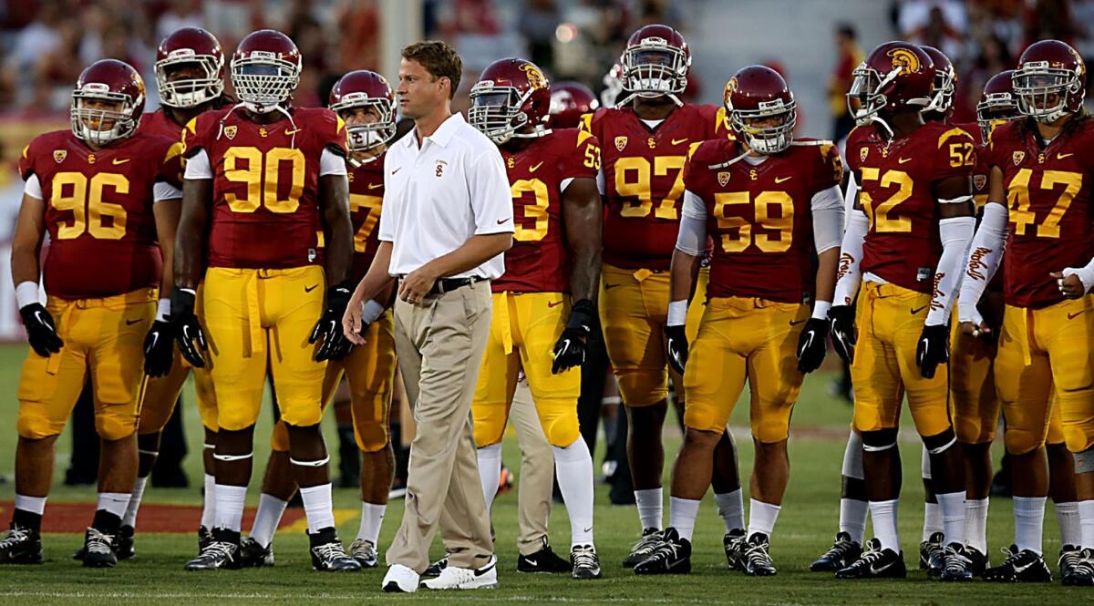 USC Coach Lane Kiffin walks in front of his players prior to the start of Saturday's game against Washington State.