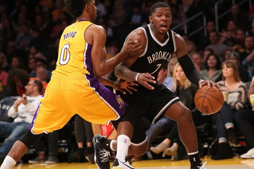 Nets guard Joe Johnson looks to drive against Lakers guard Nick Young on Friday night.