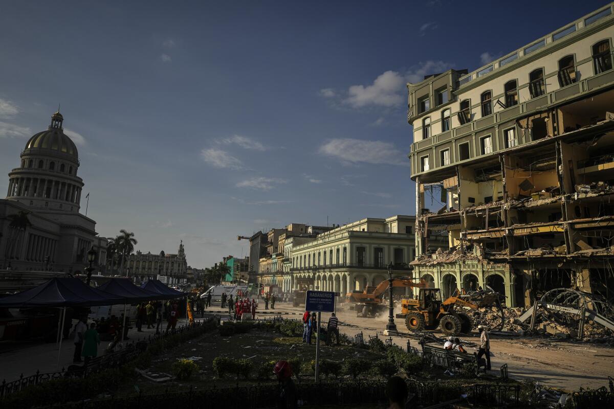 Rescue teams remove debris from the site of a deadly explosion that destroyed the five-star Hotel Saratoga.