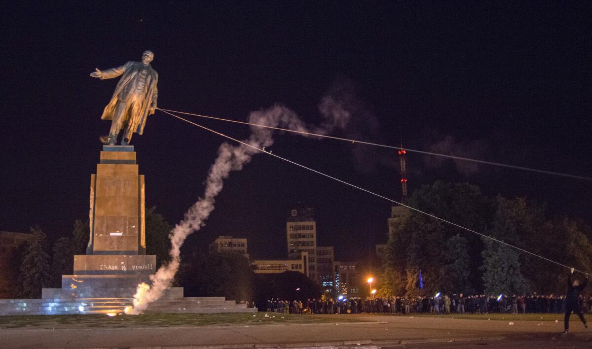 Activists dismantle Ukraine's biggest monument to Soviet founder Vladimir Lenin at a pro-Ukraine rally in Kharkiv on Sunday.