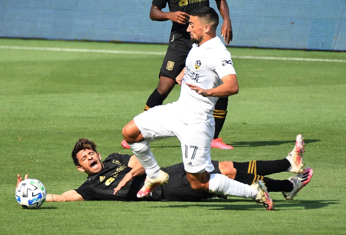The Galaxy's Sebastian Lletget, right, collides with LAFC's Adrien Perez in the second half Aug. 22, 2020.