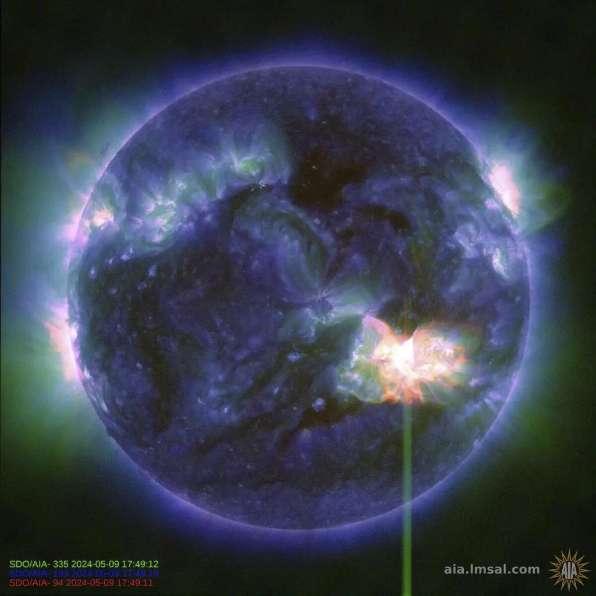 This image shows a solar flare, bright flash in lower right, captured by NASA’s Solar Dynamics Observatory on Thursday