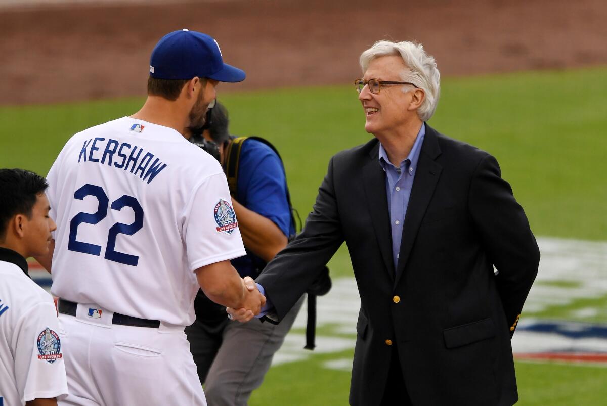 Dodgers owner Mark Walter shakes hands with pitcher Clayton Kershaw before a game at Dodger Stadium in 2018.