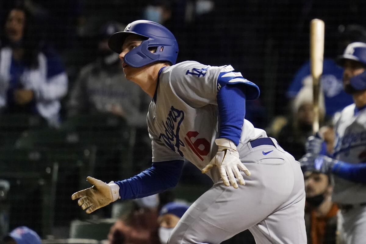 Los Angeles Dodgers' Will Smith watches after hitting a sacrifice fly to Chicago Cubs center fielder Jake Marisnick.