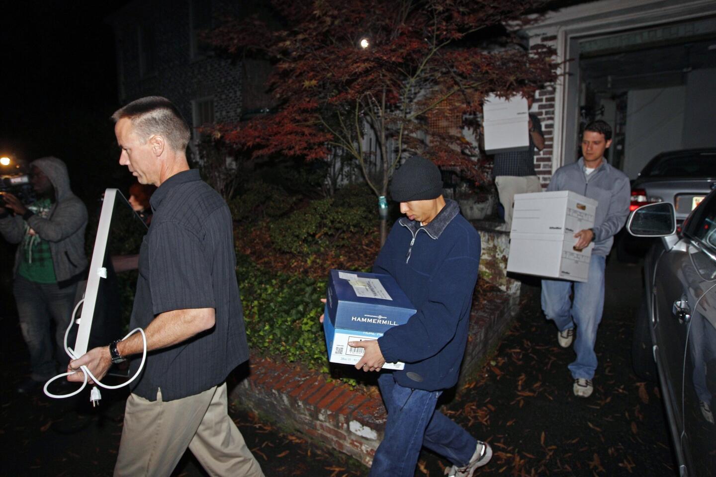 FBI agents carry boxes and a computer Tuesday from the home of Paula Broadwell, the woman whose alleged affair with retired Gen. David Petraeus led to his resignation as CIA director, in the Dilworth neighborhood of Charlotte, N.C.