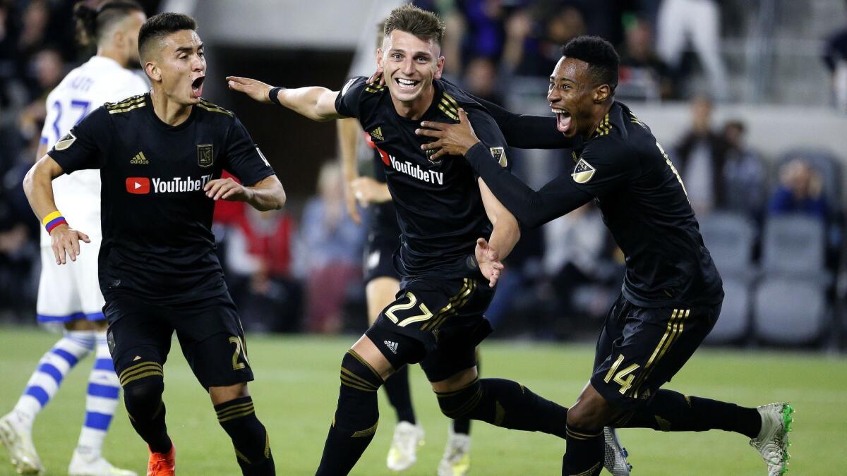 LAFC defender Tristan Blackmon, center, celebrates his goal with Christian Ramirez, left, and Mark-Anthony Kaye during a match against Montreal on May 24 at Banc of California Stadium.