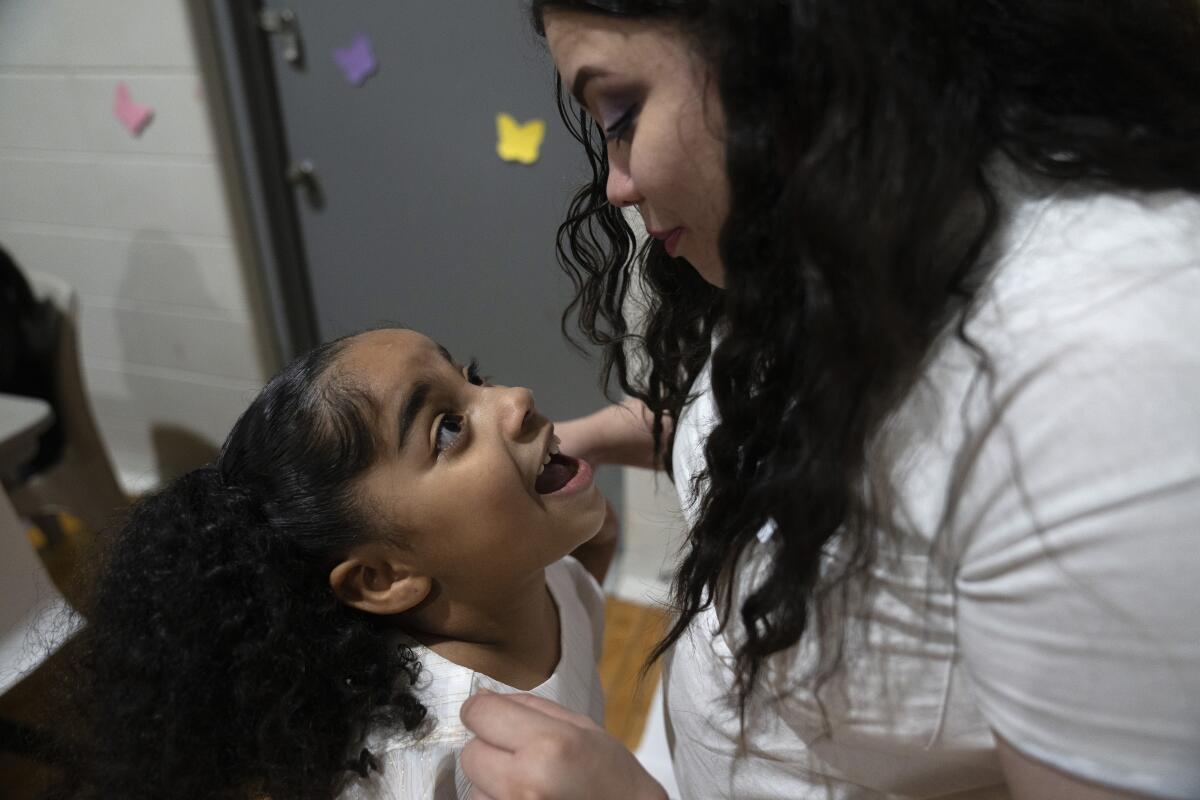 Myla Martinez, 6-year-old, enthusiastically greets her mother Crystal Martinez as she and her four younger siblings spend time her with her during a special visit at Logan Correctional Center, Saturday, May 20, 2023, in Lincoln, Illinois. Rare programs like the Reunification Ride, a donation-dependent initiative that buses prisoners' family members from Chicago to Illinois' largest women's prison every month so they can spend time with their mothers and grandmothers, are a crucial lifeline for families, prisoners say. (AP Photo/Erin Hooley)