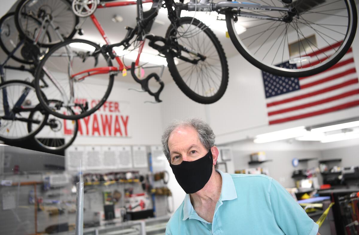 A man in a mask at a pawn shop