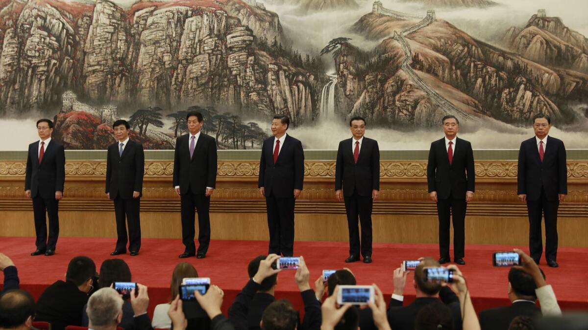 The new members of the Standing Committee of the Politburo, from left: Han Zheng, Wang Huning, Li Zhanshu, President Xi Jinping, Premier Li Keqiang, Wang Yang and Zhao Leji.