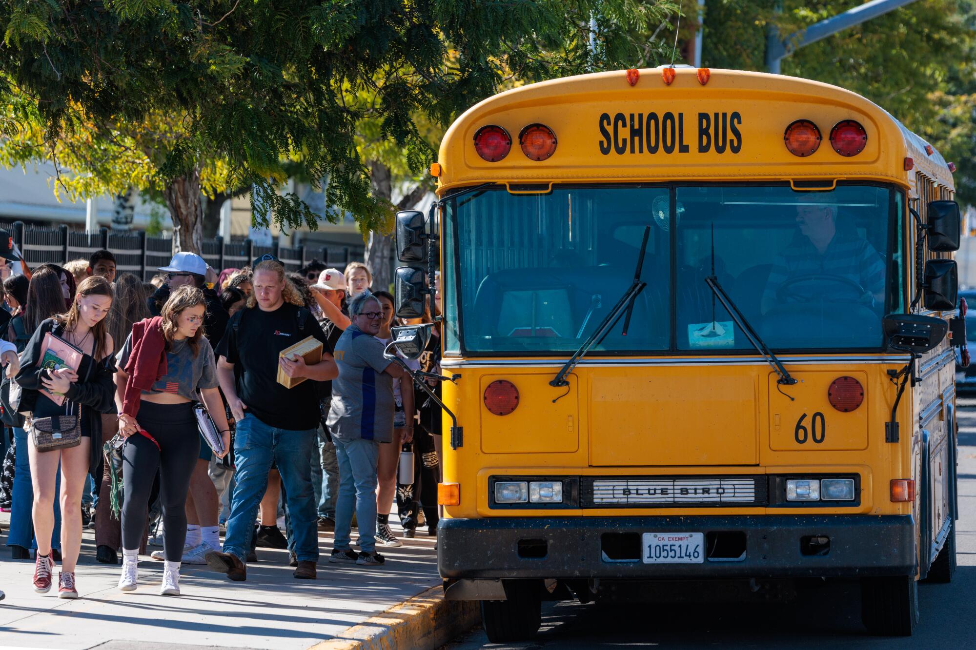 Students line up for a bus.