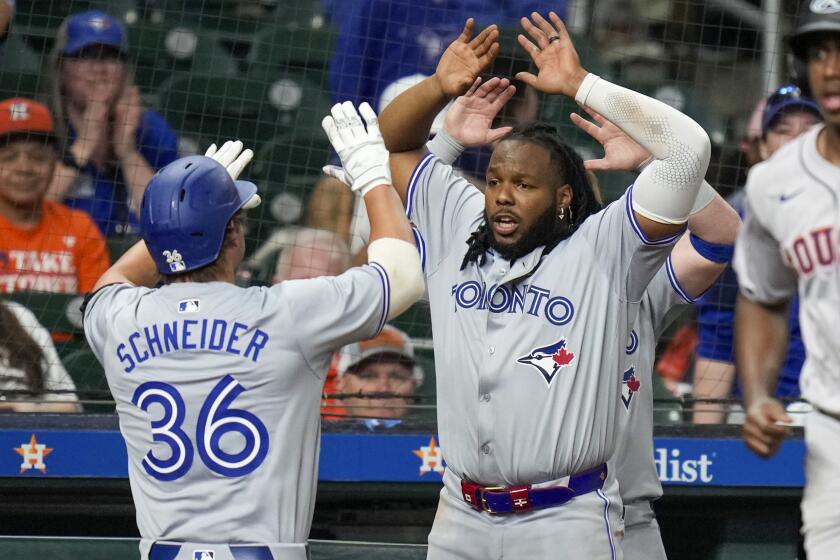 Toronto Blue Jays' Davis Schneider (36) celebrates his two-run home run against the Houston Astros with Vladimir Guerrero Jr. during the ninth inning of a baseball game Tuesday, April 2, 2024, in Houston. (AP Photo/Eric Christian Smith)