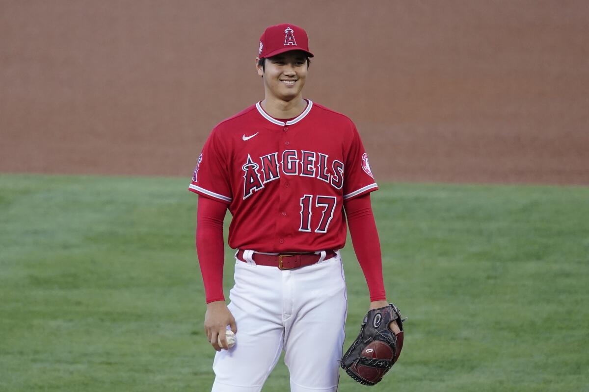 Los Angeles Angels starting pitcher Shohei Ohtani (17) smiles as he stands on the mound.