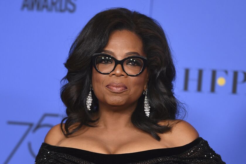 FILE - In this Jan. 7, 2018 file photo, Oprah Winfrey poses in the press room with the Cecil B. DeMille Award at the 75th annual Golden Globe Awards in Beverly Hills, Calif. Winfrey will interview two men who say Michael Jackson sexually abused them as boys immediately after a documentary on the men. HBO and the Oprah Winfrey Network announced Wednesday that After Neverland, will air on both channels Monday at 10 p.m. Eastern and Pacific. (Photo by Jordan Strauss/Invision/AP, File)