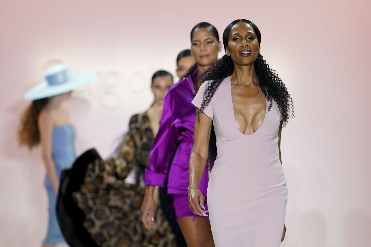 Fashion from Sergio Hudson's fall/winter 2022 collection is modeled by Beverly Johnson, front, during Fashion Week, Sunday, Feb. 13, 2022, in New York. (AP Photo/John Minchillo)