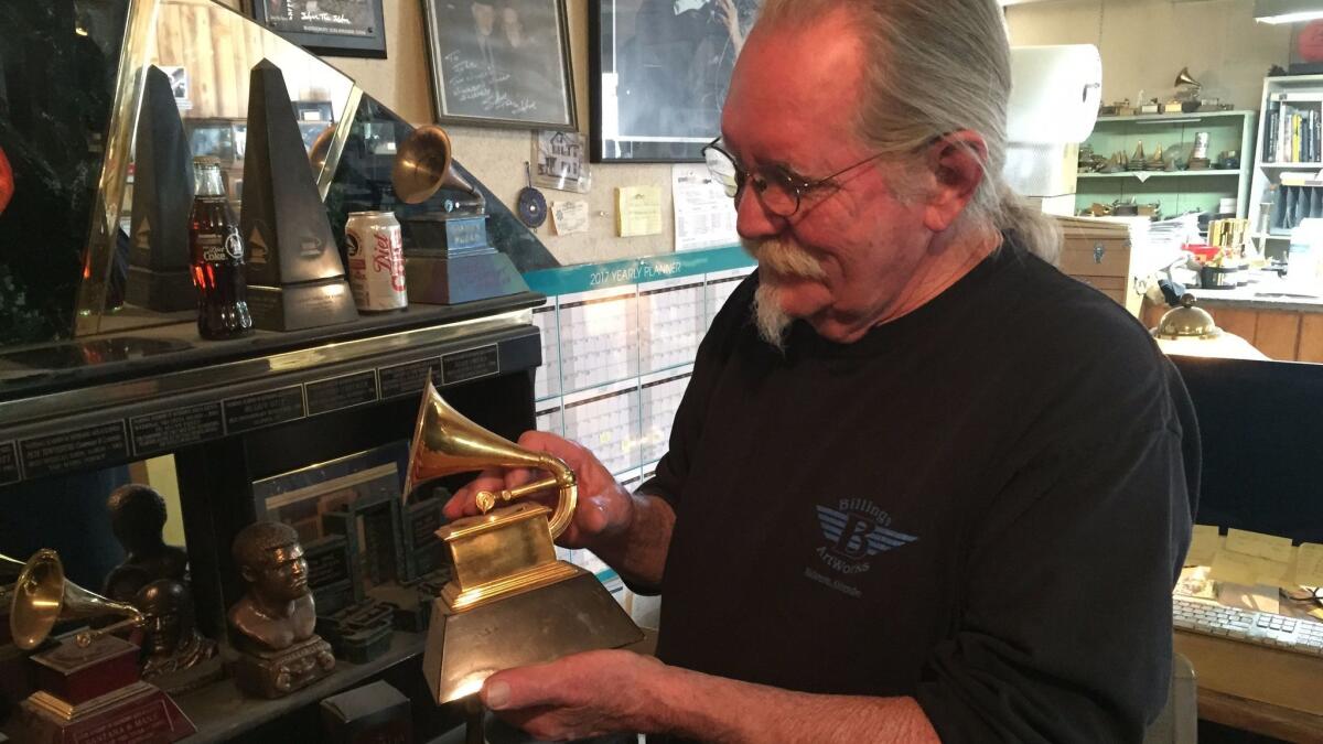 John Billings holds one of the Grammys he's made. Each one takes 15 hours of work from Billings and his three-man team.