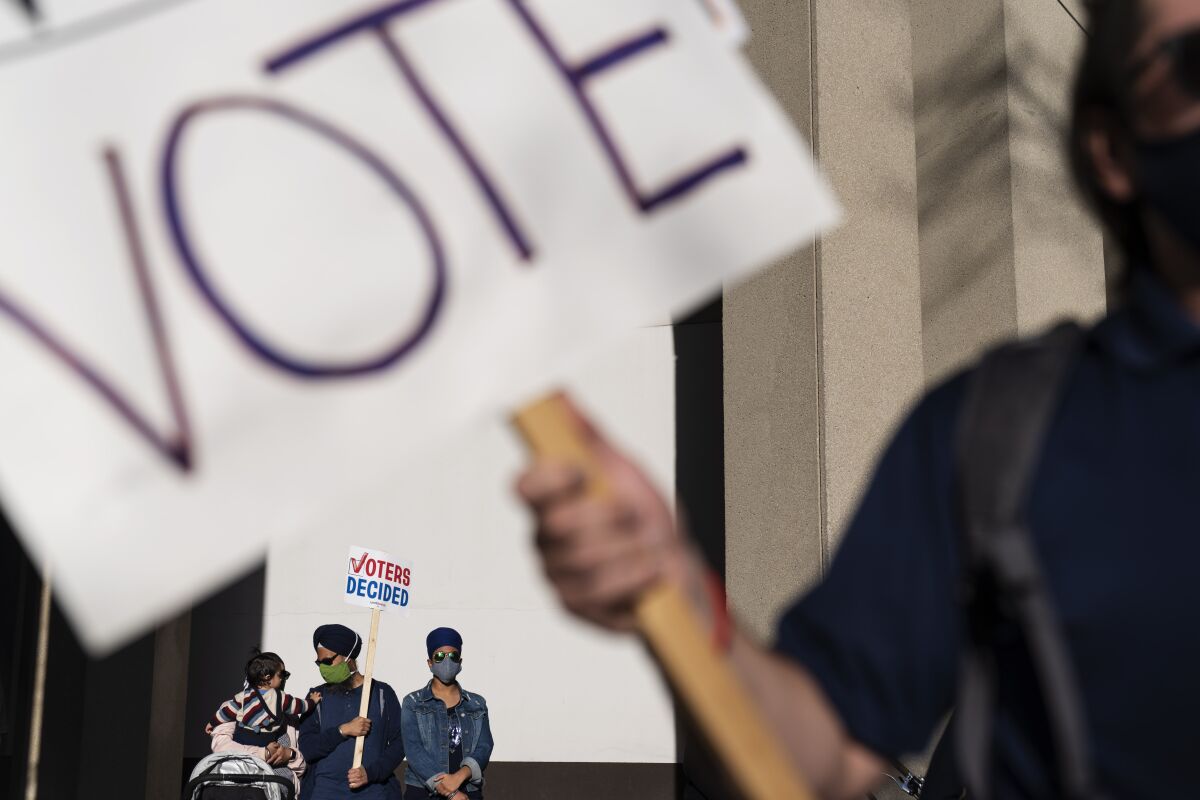 Demonstrators hold a sign saying "Voters decided" in Detroit on Nov. 7 as they celebrate the election results.