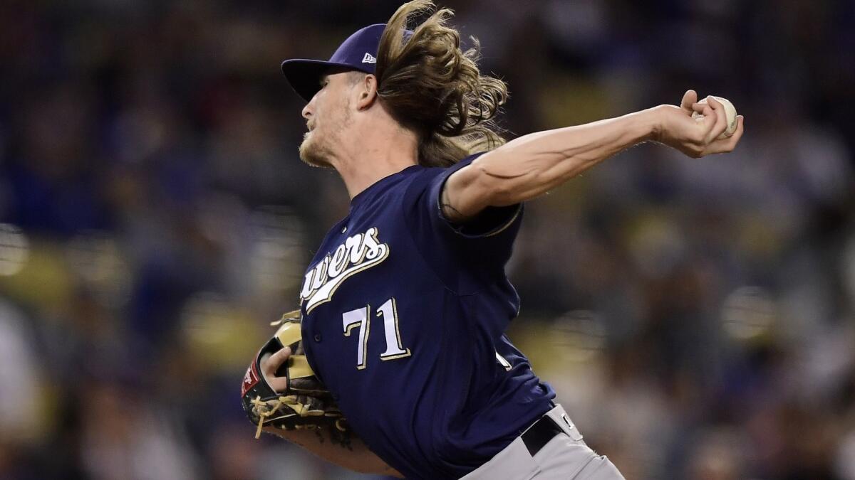 Brewers relief pitcher Josh Hader unleashes one of his 32 pitches during the eighth inning Friday night against the Dodgers.