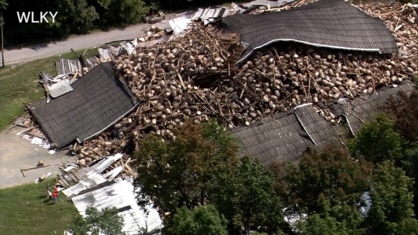 Whiskey barrels are piled in a heap Wednesday, July 4, 2018, after the rest of the Barton 1792 Distillery, a whiskey storage warehouse, collapsed in Bardstown, Kentucky, nearly two weeks after part of the decades-old structure came crashing down.
