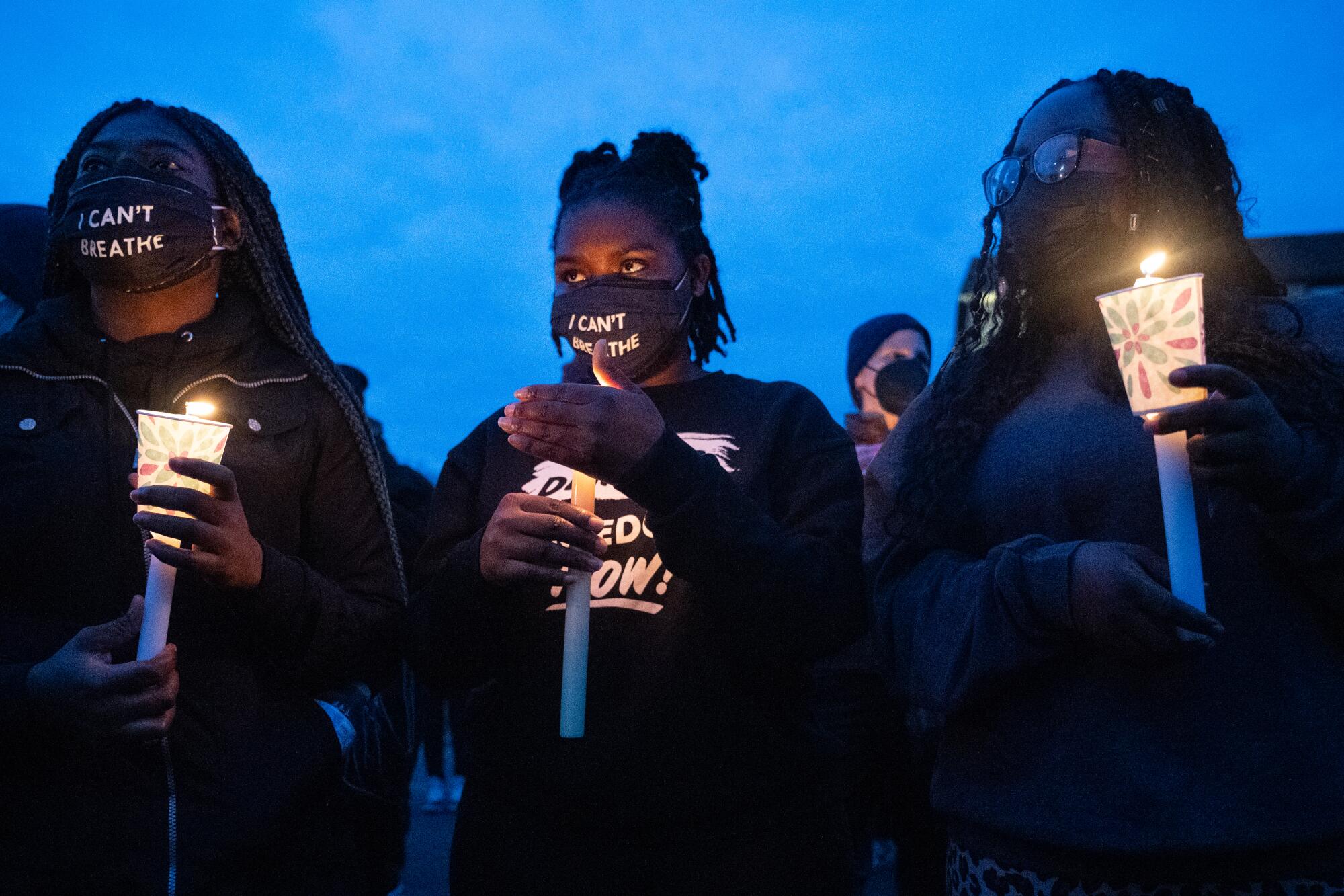 Protesters hold candles