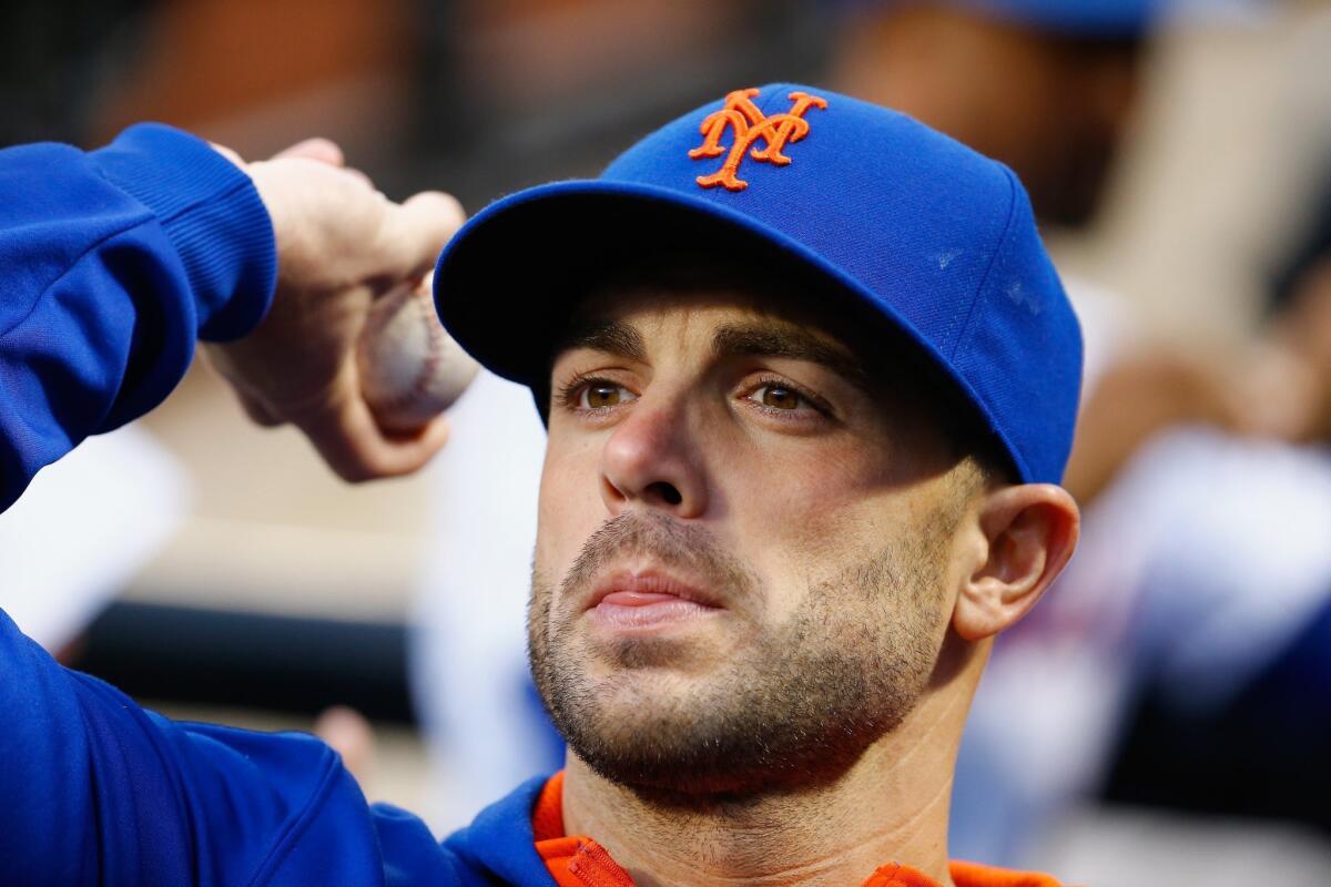 New York Mets third baseman David Wright throws back an autographed ball to a fan before a game against the Philadelphia Phillies on April 15.