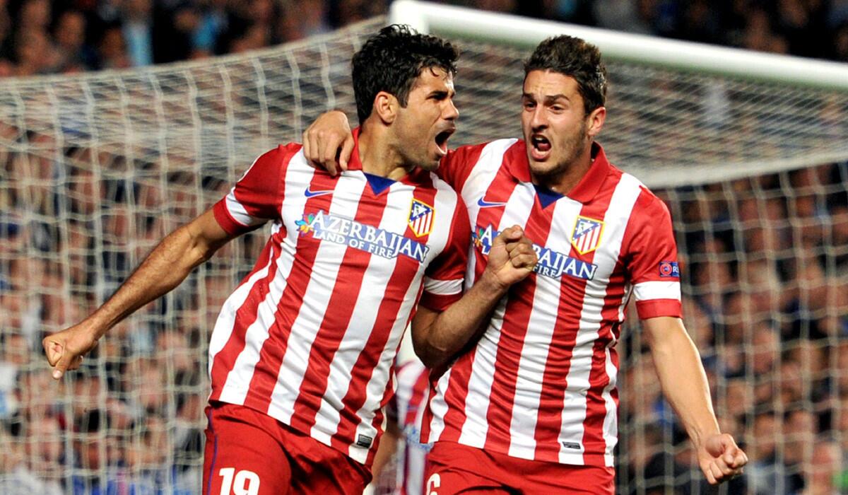 Diego Costa, left, celebrates with teammate Koke after scoring for Atletico Madreis in a Champions League game against Chelsea. Costa could provide a spark for the Spain in the World Cup this summer.