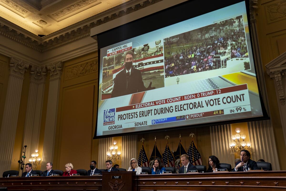 A video clip of a Fox News broadcast of the Jan. 6, 2021, insurrection is seen on screen during a hearing.
