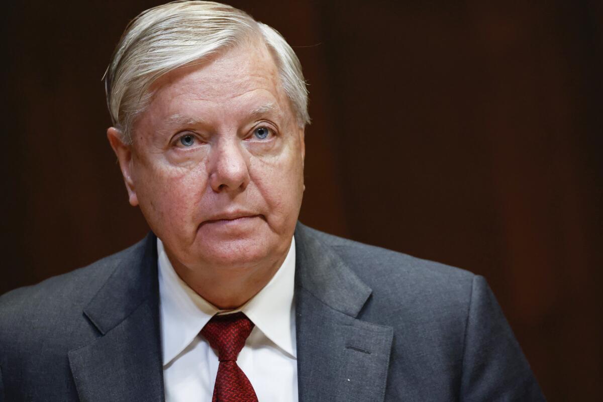 FILE - Sen. Lindsey Graham, R-S.C., listens during a hearing on the fiscal year 2023 budget for the FBI in Washington, on May 25, 2022. Attorneys for Graham said in a court filing on July 13, he wasn't trying to interfere in Georgia's 2020 election when he called state officials to ask them to reexamine certain absentee ballots after President Donald Trump's narrow loss to Democrat Joe Biden. (Ting Shen/Pool Photo via AP, File)