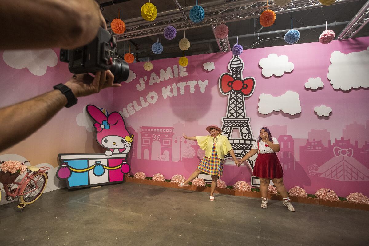 Darlene Sritapan, left, and Karen Pagtama strike a pose inside the Paris room at the Hello Kitty Friends Around the World Tour pop-up.