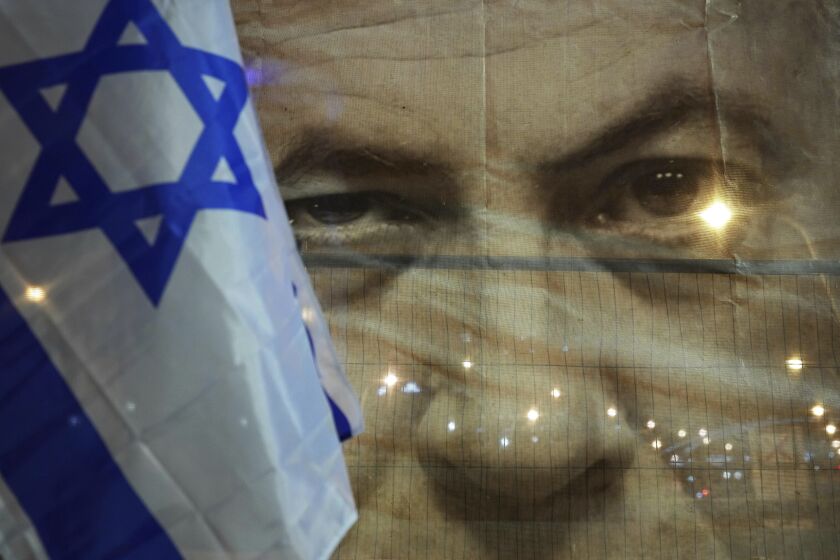 A banner depicting Israeli Prime Minister Benjamin Netanyahu is seenn during a protest against his far-right government, in Tel Aviv, Israel, Saturday, Jan. 21, 2023. Last week, tens of thousands of Israelis protested Netanyahu's government that opponents say threaten democracy and freedoms. (AP Photo/ Tsafrir Abayov)