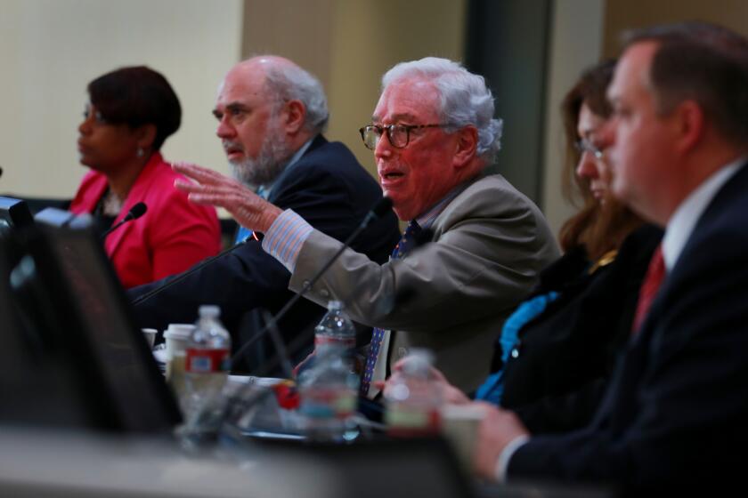 Former California Public Utilities Commission president Michael Peevey, center, at a 2013 meeting in San Diego.