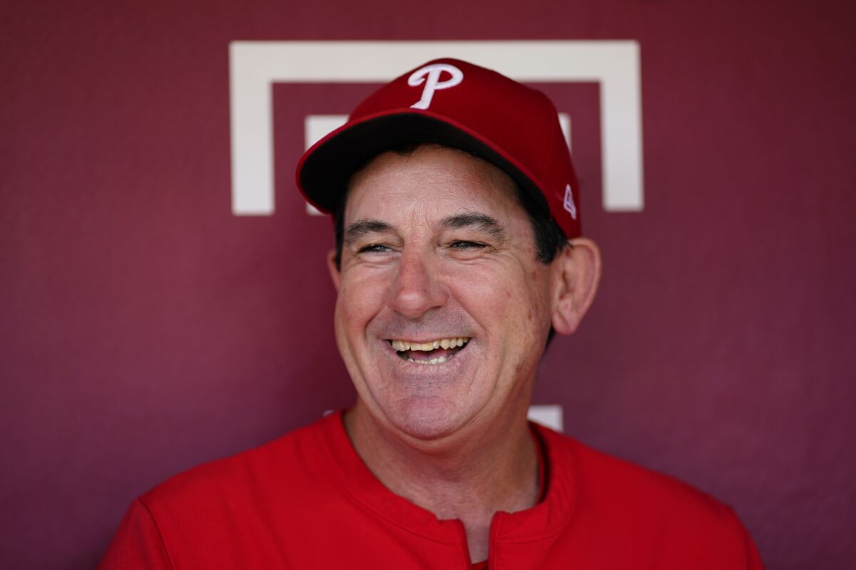 FILE - Philadelphia Phillies interim manager Rob Thomson laughs while speaking to the media before a baseball game against the Toronto Blue Jays, Sept. 21, 2022, in Philadelphia. Thomson has led his team to the brink of the playoffs. The Phillies' magic number is eight as they open a 10-game road trip Tuesday at Wrigley Field. If the Phillies keep their third wild-card spot, it’s off to St. Louis for a best-of-three series played all in Missouri. (AP Photo/Matt Slocum, File)