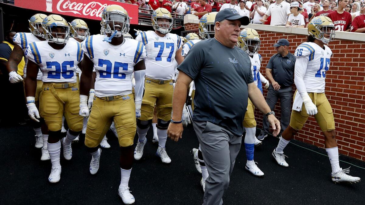 UCLA head coach Chip Kelly leads the Bruins onto the field against Oklahoma on Sept. 8, 2018.