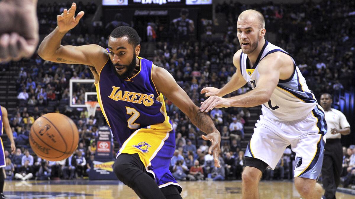Lakers guard Wayne Ellington, left, chases after the ball in front of Memphis Grizzlies guard Nick Calathes during the Lakers' 97-90 loss on March 6.