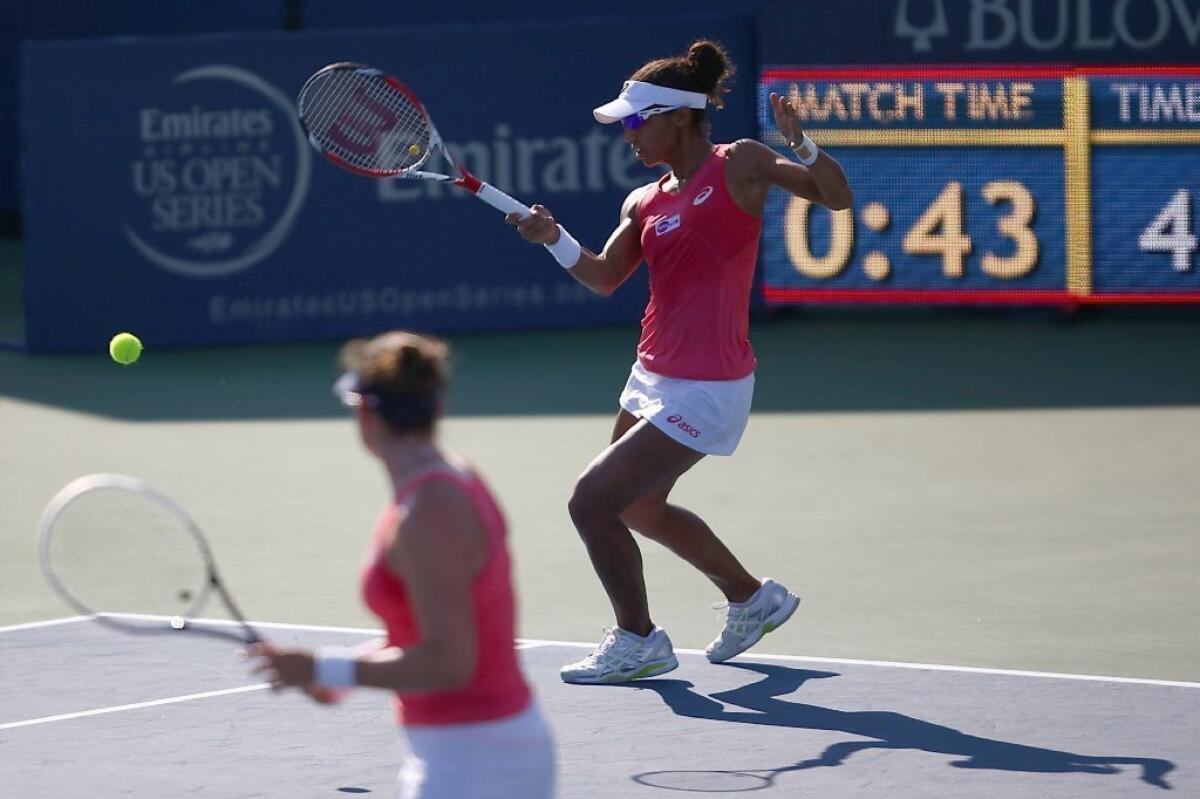 Raquel Kops-Jones smacks a shot as partner Abigail Spears looks on in their straight-set victory in the doubles final of the WTA's Southern California Open on Aug. 4 in Carlsbad.