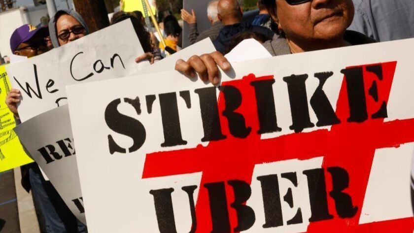 Drivers picket in Redondo Beach in protest of Uber's move to enact a 25% wage cut for its drivers on March 25.