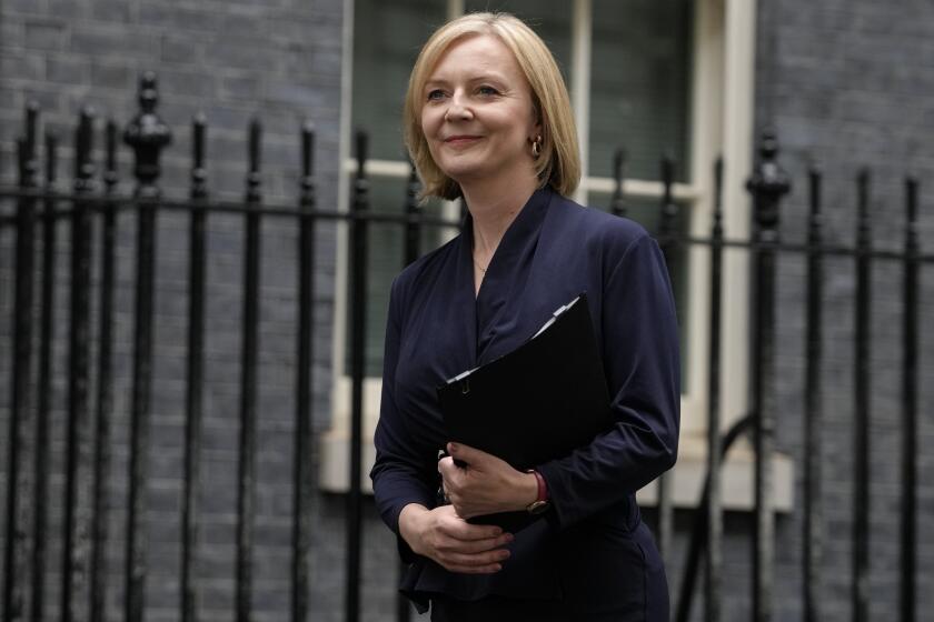 New British Prime Minister Liz Truss arrives to make an address outside Downing Street in London Tuesday, Sept. 6, 2022 after returning from Balmoral in Scotland where she was formally appointed by Britain's Queen Elizabeth II. (AP Photo/Kirsty Wigglesworth)