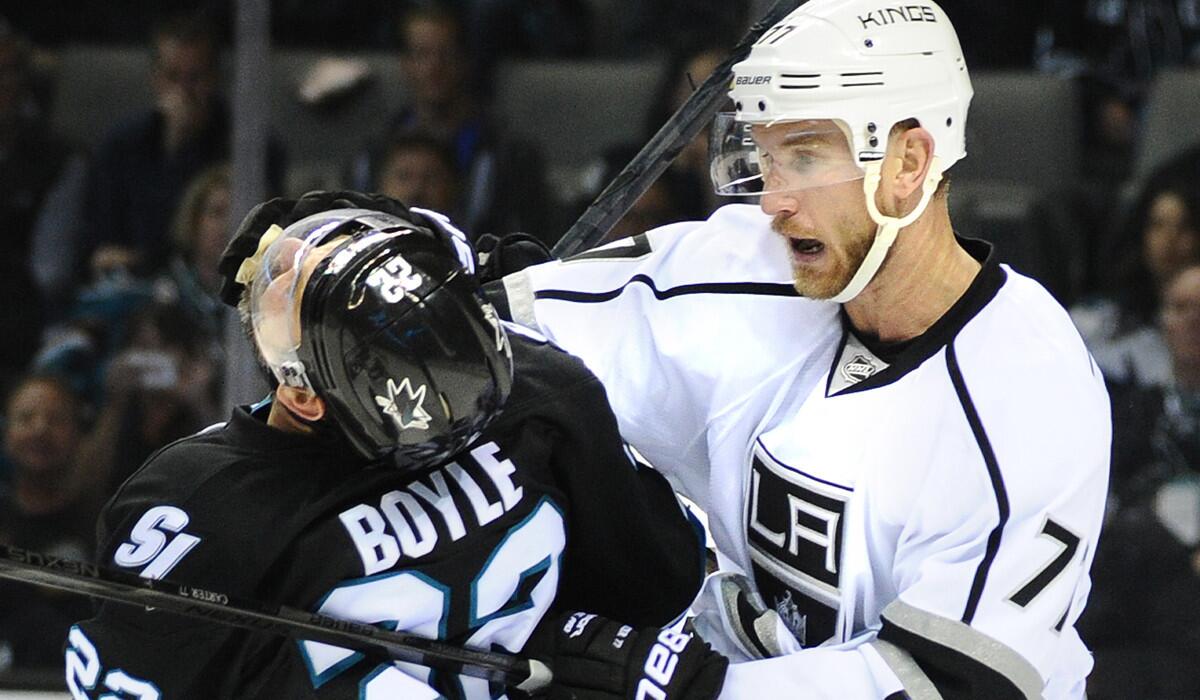 Kings forward Jeff Carter sends Sharks defenseman Dan Boyle reeling in Game 5 of their playoff series on Saturday night. Carter was called for a roughing penalty.