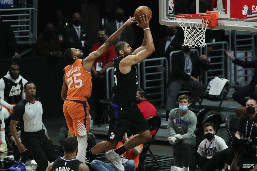 LOS ANGELES, CA - JUNE 30, 202: LA Clippers forward Nicolas Batum (33) makes an inside move to score on Phoenix Suns forward Mikal Bridges (25) in the second quarter during Game 6 of the Western Conference Finals at Staples Center on June 30, 2021 in Los Angeles, CA.(Gina Ferazzi / Los Angeles Times)