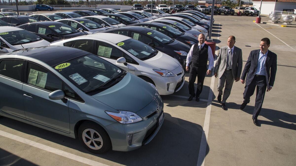 Roger Hogan, left, and sons Roger Hogan and Stephen Hogan at their family dealership Toyota of Claremont. The Hogans refused to sell these Prius vehicles, believing they were not safe to drive because the power system has a defect.