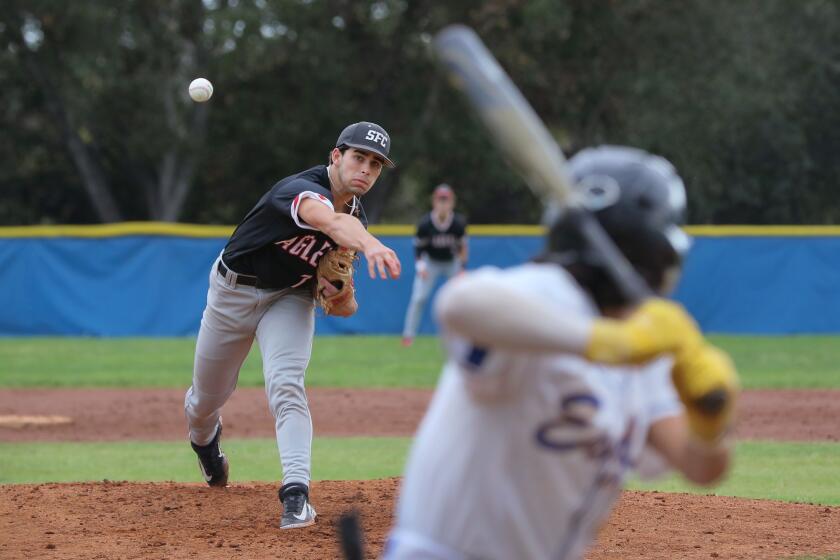 Escondido, CA - March 12: Prep Baseball- Santa Fe Christian at San Pasqual- Santa Fe Christian pitcher Will Marenghi fires to the plate early in the game. At bat is San Pasqual's Osa Hinojosa. (Charlie Neuman / For The San Diego Union-Tribune)