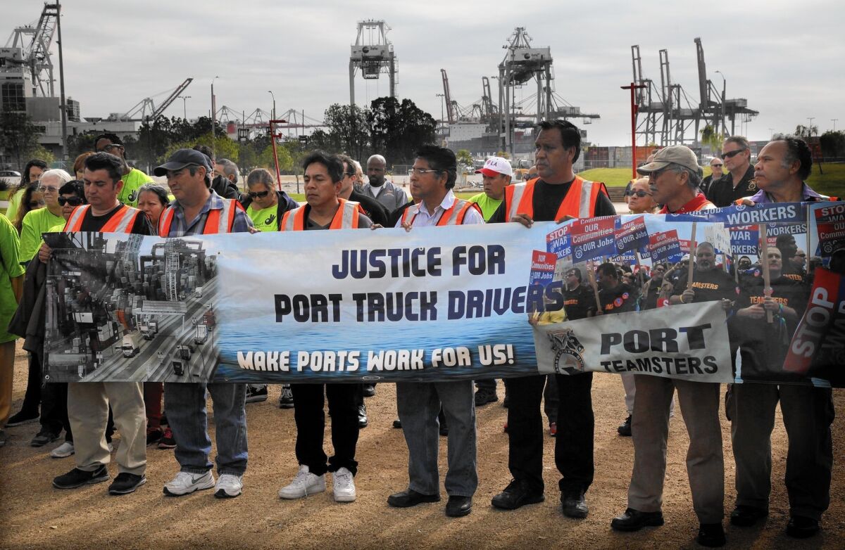Striking truck drivers from two short-haul firms serving the ports of Long Beach and Los Angeles participate in a noontime rally at Wilmington Waterfront Park. Cargo is still moving through the ports as other unions are not joining the walkout.