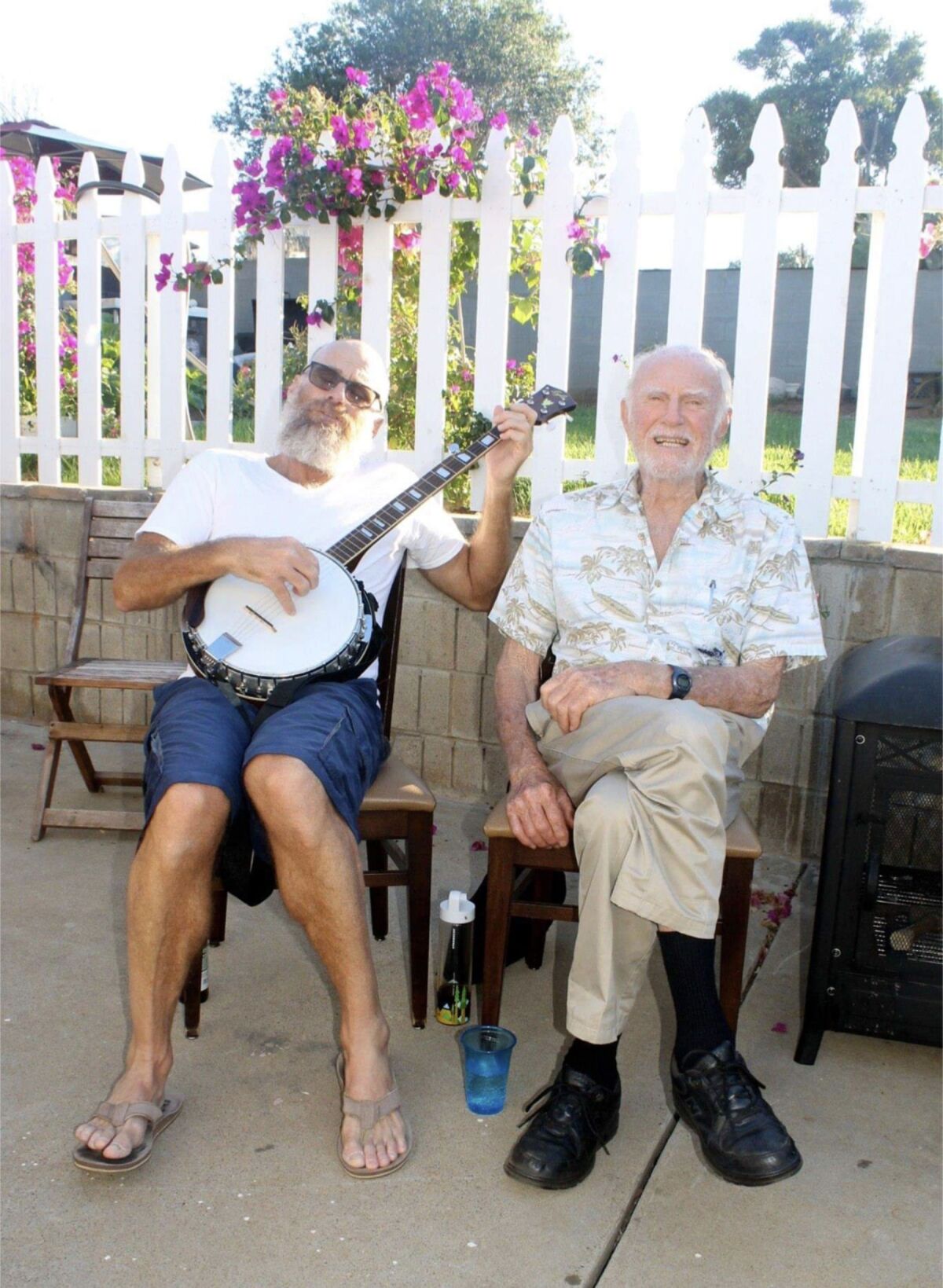 Musician and songwriter Chris Ryan, playing a five-string banjo, with his father, Roger Ryan.