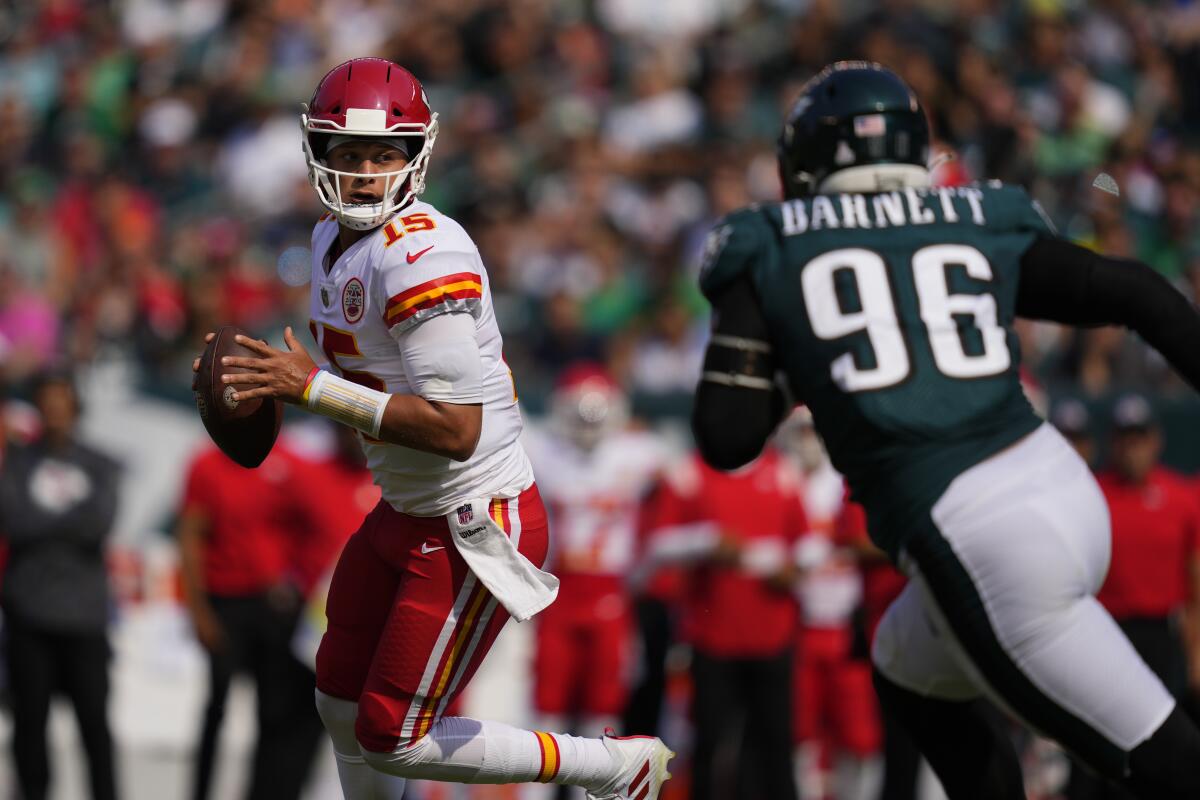 Kansas City Chiefs quarterback Patrick Mahomes passes in front of Philadelphia Eagles defensive end Derek Barnett.