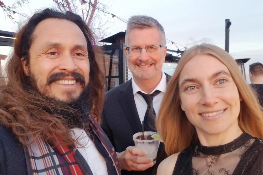 Mark Sawusch, center, has a cocktail with Anthony Flores and Anna Moore in 2017.