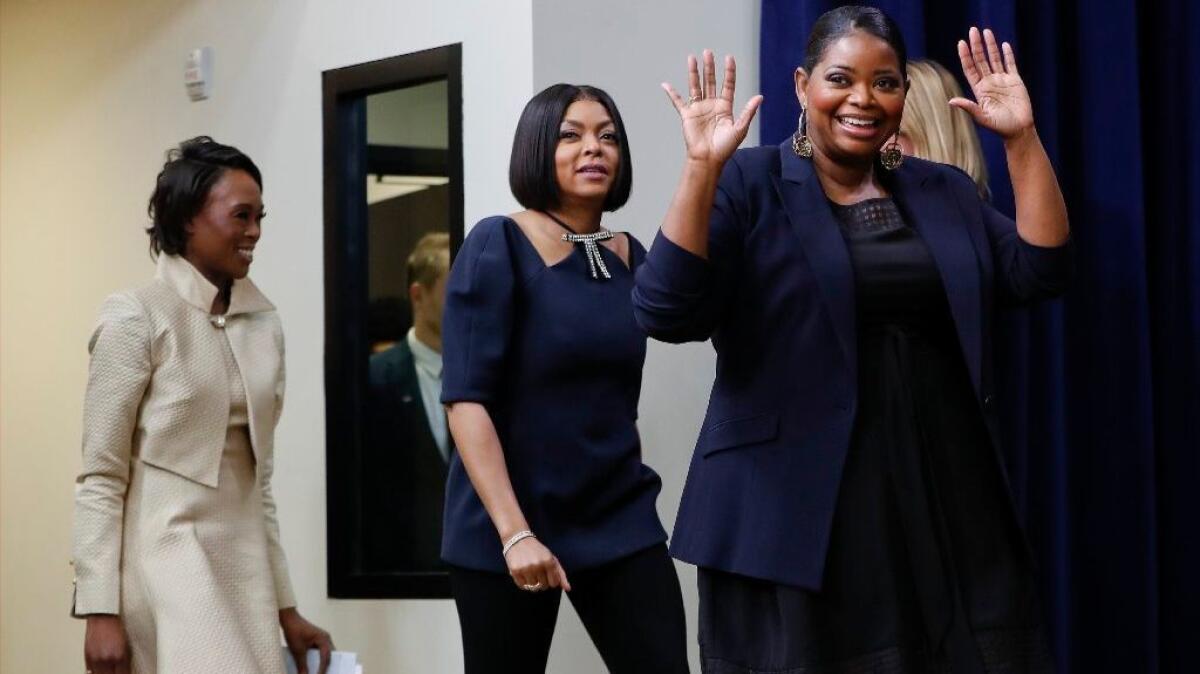 From left, author Margot Lee Shetterly, wearing a dress and jacket by L.A. designer Raymond McNeill, with Taraji P. Henson and Octavia Spencer are introduced after a screening of the movie "Hidden Figures" at the White House in Washington on Dec. 15, 2016.