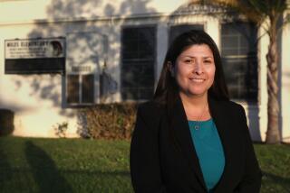 Huntington Park, CA - December 14: Huntington Park Council Member Graciela Ortiz poses for a portrait in front of her stomping grounds of her alma mater at Miles Elementary on Thursday, Dec. 14, 2023 in Huntington Park, CA. (Michael Blackshire / Los Angeles Times)
