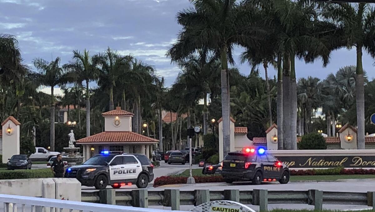 Police respond to the Trump National Doral resort after reports of a shooting Friday.