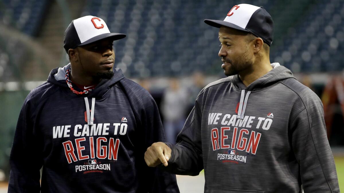Indians outfielders Raja Davis, left, and Coco Crisp chat during batting practice Thursday in Cleveland.