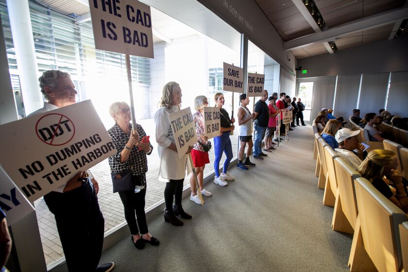 Newport Beach, CA - September 27: Friends of Newport Harbor stand in the back of the Newport Beach City Council Chambers to protest a proposed dump site in Newport Bay on Tuesday, Sept. 27, 2022 in Newport Beach, CA. (Scott Smeltzer / Daily Pilot)