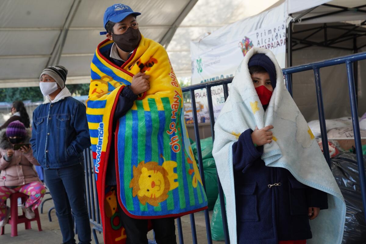 Families line up last week for COVID-19 tests at a testing center in Mexico City's Iztapalapa district.